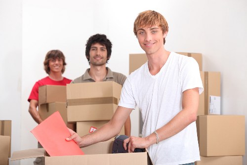 Crystal Palace moving experts transporting furniture near a residential street